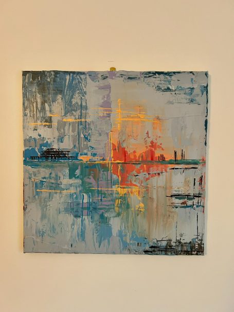 Abstract landscape with vibrant colours reflecting water and urban silhouettes.